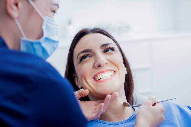 photo of a woman smiling at the dentist during a dental appointment