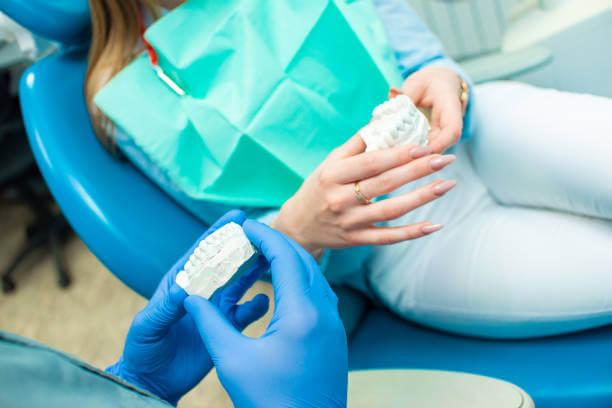 dentist explaining non-surgical periodontal treatment to a patient during a dental consultation