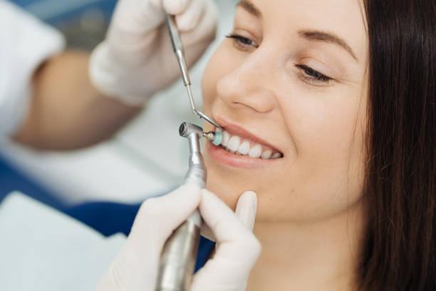 a dentist performing dental cleaning