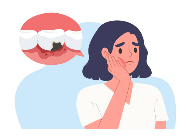 a young woman holding her cheek due to tooth pain from cavities