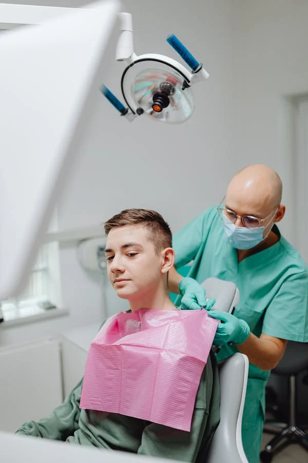 a dental professional preparing his patient before a dental treatment